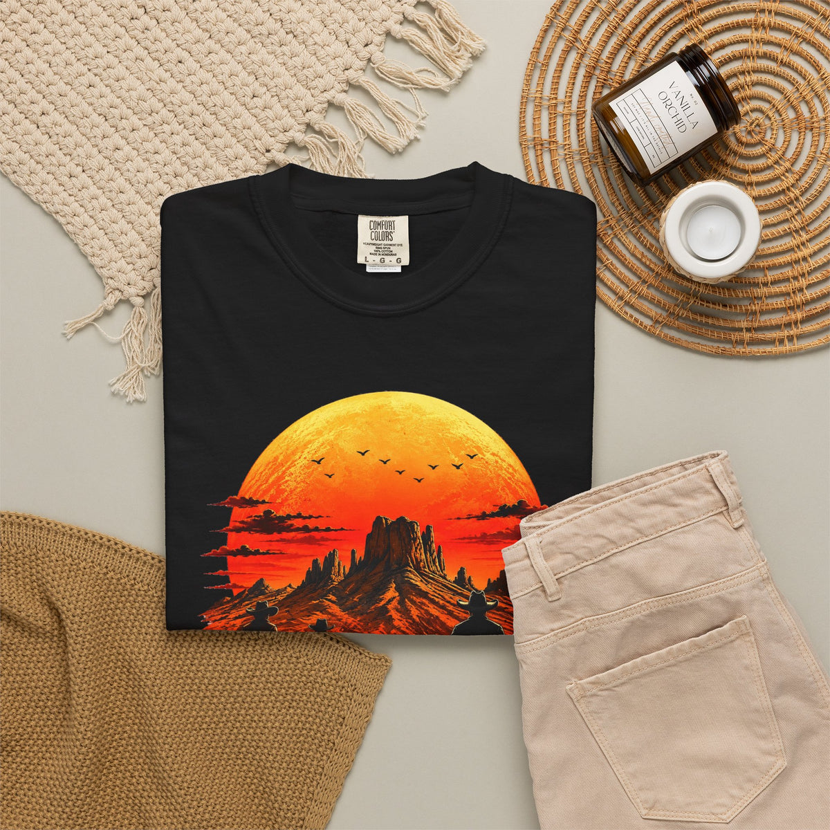 Black Western Sunset Riders graphic tee styled with neutral denim flat lay